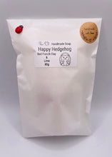 Load image into Gallery viewer, Handmade vegan soaps featuring a cute waving hedgehog, packaged in beautiful eco friendly packaging. crafted with natural French clays, activated charcoal and essential oils. a eco-friendly, zero waste gift that’s cruelty-free, skin-nourishing, the perfect gift for hedgehog lovers and animal lovers. small business UK