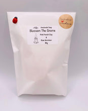 Load image into Gallery viewer, Handmade vegan soaps featuring a gorgeous gnome holding a bunch of flowers in one hand and waving with the other hand. beautiful eco friendly packaging. crafted with natural French clays, activated charcoal and essential oils. a eco-friendly, zero waste gift that’s cruelty-free, skin-nourishing, and perfect for gnome lovers and gifting. UK Small Business