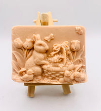 Load image into Gallery viewer, Handmade vegan soaps featuring the easter bunny with a basket full of chicks. , in beautiful eco friendly packaging. crafted with natural French clays, activated charcoal and essential oils. a eco-friendly, zero waste gift that’s cruelty-free, skin-nourishing, the perfect gift for easter and animal lovers. small business UK