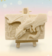 Load image into Gallery viewer, Dragon gift. Dinosaur gift. Our Flying Dragon soap features a striking dragon with its majestic wings spread wide, symbolising freedom and power. This artisan bar is vegan, cruelty-free, and designed with care for both your skin and the planet. Available in your choice of colour and essential oil. Each soap comes beautifully wrapped in eco friendly packaging. zero waste gift. kodern gift ideas. handmade home style. eco conscious home. eco friendly gifts. go green home.
