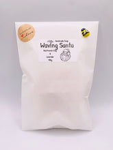 Load image into Gallery viewer, Christmas Gift | Secret Santa Gift | Stocking Filler | Father Christmas Gift | Santa Claus Gift | Christmas Tree Gift | Waving Santa Vegan Soap. Eco conscious gifts. This adorable waving Santa soap is available in your choice of French clay and essential oil. The perfect Christmas gift or stocking filler! 
Available in your choice of colour and essential oil.