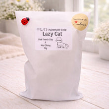 Load image into Gallery viewer, White bag of 'Lazy Cat' handmade soap with a label on a light wooden surface.