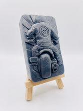 Load image into Gallery viewer, detailed handmade vegan soap gift featuring a motorcycle rider with a skull emblem on their jacket, displayed on a wooden easel against a whimsical farmhouse decor background