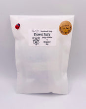 Load image into Gallery viewer, Handmade vegan soaps featuring a fairy sitting on leaves and holding a flower in beautiful eco friendly packaging. crafted with natural French clays, activated charcoal and essential oils. a eco-friendly, zero waste gift that’s cruelty-free, skin-nourishing, the perfect gift for fairy lovers or mothers day. small business UK