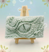 Load image into Gallery viewer, dragon Gift | dragon eye gift, dino gift, alternative gift, Dragon / Dinosaur Eye Vegan Soap Wooden display easels are available to purchase on a separate listing Calling all fantasy lovers! Step into a realm of mystical charm with our captivating dragon / dinosaur eye soap. This soap is vegan, cruelty free and available in your choice of colour and essential oil. All our soaps are made with natural clays and essential oils to gently cleanse and nourish your skin. eco conscious gift