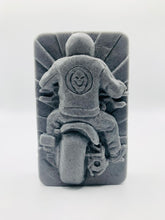 Load image into Gallery viewer, detailed handmade vegan soap gift featuring a motorcycle rider with a skull emblem on their jacket, displayed on a wooden easel against a whimsical farmhouse decor background