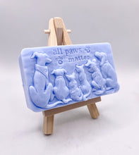 Load image into Gallery viewer, dog lover gift. cat lover gift. animal lover gift. zero waste gift. modern gifts. handmade home style. This beautifully detailed, chunky bar features a line-up of our loyal four-legged friends, reminding us of the love, joy, and muddy footprints they bring into our lives. The one in the photo is made with charcoal and lavender essential oil, soothing, earthy, and perfect for washing the day away (or after a long dog walk!). eco conscious home. eco conscious living.
