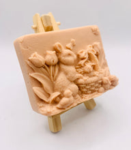 Load image into Gallery viewer, Handmade vegan soaps featuring the easter bunny with a basket full of chicks. , in beautiful eco friendly packaging. crafted with natural French clays, activated charcoal and essential oils. a eco-friendly, zero waste gift that’s cruelty-free, skin-nourishing, the perfect gift for easter and animal lovers. small business UK