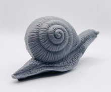 Load image into Gallery viewer, Handmade vegan soaps featuring a detailed snail, in beautiful eco friendly packaging. crafted with natural French clays, activated charcoal and essential oils. a eco-friendly, zero waste gift that’s cruelty-free, skin-nourishing, the perfect gift for snail lovers, gardeners or for animal lovers. small business UK