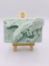 Load image into Gallery viewer, Dragon gift. Dinosaur gift. Our Flying Dragon soap features a striking dragon with its majestic wings spread wide, symbolising freedom and power. This artisan bar is vegan, cruelty-free, and designed with care for both your skin and the planet. Available in your choice of colour and essential oil. Each soap comes beautifully wrapped in eco friendly packaging. zero waste gift. kodern gift ideas. handmade home style. eco conscious home. eco friendly gifts. go green home.