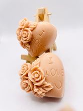 Load image into Gallery viewer, Handmade vegan soaps featuring a set of two love heart soaps with wording I LOVE U with flowers, gift boxed in beautiful eco friendly packaging. crafted with natural French clays, activated charcoal and essential oils. a eco-friendly, zero waste gift that’s cruelty-free, skin-nourishing, and perfect for romantic valentines gifts and anniversary gifts. small business UK