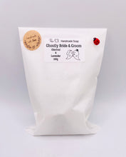 Load image into Gallery viewer, Handmade vegan soaps shaped as a ghost bride and groom. crafted with natural French clays, activated charcoal and essential oils. a eco-friendly, zero waste gift that’s cruelty-free, skin-nourishing, and perfect for Halloween weddings and gifting.
small business UK