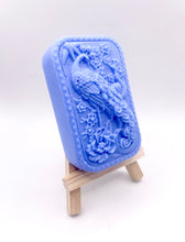 Load image into Gallery viewer, Handmade vegan soaps featuring a detailed peacock, in beautiful eco friendly packaging. crafted with natural French clays, activated charcoal and essential oils. a eco-friendly, zero waste gift that’s cruelty-free, skin-nourishing, the perfect gift for peacock lovers or for animal lovers. small business UK