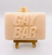 Load image into Gallery viewer, Handmade vegan soap featuring the writing GAY BAR and packaged in beautiful eco friendly packaging. crafted with natural French clays, activated charcoal and essential oils. a eco-friendly, zero waste gift that’s cruelty-free, skin-nourishing, and perfect for pride Gifts and novelty themed gifts. Small business UK