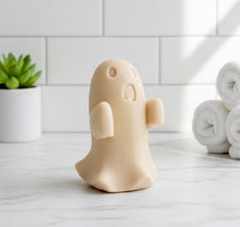 Load image into Gallery viewer, Ghost-shaped soap on a bathroom counter with towels and a plant in the background