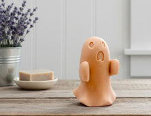 Load image into Gallery viewer, Ghost-shaped soap on a wooden surface with a plant and soap dish in the background.