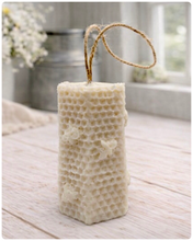 Load image into Gallery viewer, A tall, rectangular handmade vegan soap with a detailed honeycomb texture on all sides and small embossed bees, featuring a natural twine hanging rope, displayed upright on a light wooden surface.