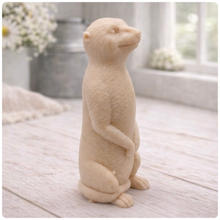Load image into Gallery viewer, A highly detailed handmade vegan soap, sculpted in the shape of a realistic meerkat standing upright in its iconic sentinel pose, featuring textured fur and a curious facial expression, displayed on a light wooden surface.