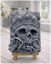 Load image into Gallery viewer, handmade vegan soap gift featuring a detailed relief of a skull wearing a crown, surrounded by a border of roses, displayed on a small wooden easel.
