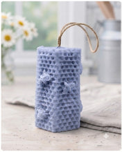 Load image into Gallery viewer, A tall, rectangular handmade vegan soap with a detailed honeycomb texture on all sides and small embossed bees, featuring a natural twine hanging rope, displayed upright on a light wooden surface.