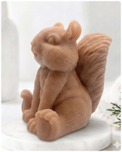 Load image into Gallery viewer, Handmade 3D squirrel-shaped soap sitting upright on a white marble display stand, featuring detailed textured fur and a bushy tail.