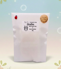 Load image into Gallery viewer, Handmade vegan soaps featuring two nuzzling giraffes in beautiful eco friendly packaging. crafted with natural French clays, activated charcoal and essential oils. a eco-friendly, zero waste gift that’s cruelty-free, skin-nourishing, the perfect gift for giraffe lovers, or for animal lover gifts. small business UK