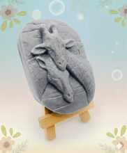 Load image into Gallery viewer, Handmade vegan soaps featuring two nuzzling giraffes in beautiful eco friendly packaging. crafted with natural French clays, activated charcoal and essential oils. a eco-friendly, zero waste gift that’s cruelty-free, skin-nourishing, the perfect gift for giraffe lovers, or for animal lover gifts. small business UK