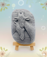 Load image into Gallery viewer, Handmade vegan soaps featuring two nuzzling giraffes in beautiful eco friendly packaging. crafted with natural French clays, activated charcoal and essential oils. a eco-friendly, zero waste gift that’s cruelty-free, skin-nourishing, the perfect gift for giraffe lovers, or for animal lover gifts. small business UK