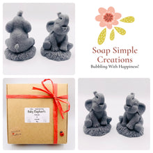 Load image into Gallery viewer, Handmade vegan soaps featuring a set of two baby elephants, gift boxed in beautiful eco friendly packaging. crafted with natural French clays, activated charcoal and essential oils. a eco-friendly, zero waste gift that’s cruelty-free, skin-nourishing, the perfect gift for elephant lovers or for animal lovers. small business UK