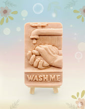 Load image into Gallery viewer, Our unique “Wash Me” soap features a playful design of a pair of hands washing under a tap, complete with the words “WASH ME” imprinted at the bottom. Made from 100% vegan, cruelty-free ingredients, our soap is as kind to the planet as it is to your skin. Customise your bar by choosing your favourite colour and essential oil.