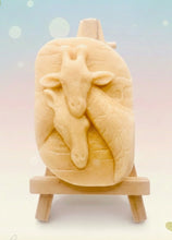 Load image into Gallery viewer, Handmade vegan soaps shaped as two nuzzling giraffes. crafted with natural French clays, activated charcoal and essential oils. a eco-friendly, zero waste gift that’s cruelty-free, skin-nourishing, and perfect for animal lovers and gifting . Beautifully wrapped in eco friendly packaging. Small business UK