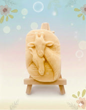 Load image into Gallery viewer, Handmade vegan soaps shaped as two nuzzling giraffes. crafted with natural French clays, activated charcoal and essential oils. a eco-friendly, zero waste gift that’s cruelty-free, skin-nourishing, and perfect for animal lovers and gifting . Beautifully wrapped in eco friendly packaging. Small business UK