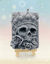 Load image into Gallery viewer, Handmade vegan soaps featuring a skull wearing a crown surrounded by roses. crafted with natural French clays, activated charcoal and essential oils. a eco-friendly, zero waste gift that’s cruelty-free, skin-nourishing, and perfect for skull lovers and Halloween gifting .