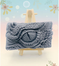 Load image into Gallery viewer, dragon Gift | dragon eye gift, dino gift, alternative gift, Dragon / Dinosaur Eye Vegan Soap Wooden display easels are available to purchase on a separate listing Calling all fantasy lovers! Step into a realm of mystical charm with our captivating dragon / dinosaur eye soap. This soap is vegan, cruelty free and available in your choice of colour and essential oil. All our soaps are made with natural clays and essential oils to gently cleanse and nourish your skin. eco conscious gift