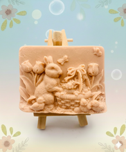 Load image into Gallery viewer, Handmade vegan soaps featuring the easter bunny with a basket full of chicks. , in beautiful eco friendly packaging. crafted with natural French clays, activated charcoal and essential oils. a eco-friendly, zero waste gift that’s cruelty-free, skin-nourishing, the perfect gift for easter and animal lovers. small business UK