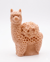Load image into Gallery viewer, A 3D handmade vegan soap featuring a charming llama or alpaca with a highly textured, fleecy coat and a blanket of intricate flowers across its back, displayed on a light wooden surface in a bright room.