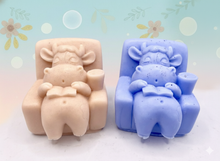 Load image into Gallery viewer, Handmade vegan cow sleeping on the sofa with book and coffee, shaped vegan soaps gift boxed. crafted with natural French clays, activated charcoal and essential oils. a eco-friendly, zero waste gift that’s cruelty-free, skin-nourishing, and perfect for animal lovers and gifting. small business UK
