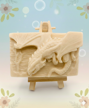 Load image into Gallery viewer, Dragon gift. Dinosaur gift. Our Flying Dragon soap features a striking dragon with its majestic wings spread wide, symbolising freedom and power. This artisan bar is vegan, cruelty-free, and designed with care for both your skin and the planet. Available in your choice of colour and essential oil. Each soap comes beautifully wrapped in eco friendly packaging. zero waste gift. kodern gift ideas. handmade home style. eco conscious home. eco friendly gifts. go green home.