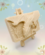 Load image into Gallery viewer, Dragon gift. Dinosaur gift. Our Flying Dragon soap features a striking dragon with its majestic wings spread wide, symbolising freedom and power. This artisan bar is vegan, cruelty-free, and designed with care for both your skin and the planet. Available in your choice of colour and essential oil. Each soap comes beautifully wrapped in eco friendly packaging. zero waste gift. kodern gift ideas. handmade home style. eco conscious home. eco friendly gifts. go green home.