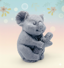 Load image into Gallery viewer, Handmade vegan soaps featuring a chunky koala bear climbing a tree packaged in beautiful eco friendly packaging crafted with natural French clays, activated charcoal and essential oils. a eco-friendly, zero waste gift that’s cruelty-free, skin-nourishing, and perfect for koala bear lovers and animal themed gifts. small business UK