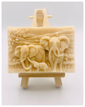 Load image into Gallery viewer, Handmade vegan soap featuring an elephant family with baby elephant and packed in beautiful eco friendly packaging. crafted with natural French clays, activated charcoal and essential oils. a eco-friendly, zero waste gift that’s cruelty-free, skin-nourishing, and perfect for elephant lovers or animal themed gifts. Small business UK