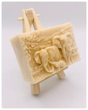 Load image into Gallery viewer, Handmade vegan soap featuring an elephant family with baby elephant and packed in beautiful eco friendly packaging. crafted with natural French clays, activated charcoal and essential oils. a eco-friendly, zero waste gift that’s cruelty-free, skin-nourishing, and perfect for elephant lovers or animal themed gifts. Small business UK