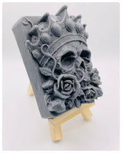 Load image into Gallery viewer, Handmade vegan soaps featuring a skull wearing a crown surrounded by roses. crafted with natural French clays, activated charcoal and essential oils. a eco-friendly, zero waste gift that’s cruelty-free, skin-nourishing, and perfect for skull lovers, gifts for him and Halloween gifting . Small business UK