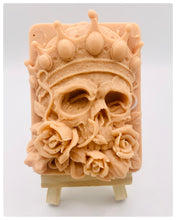Load image into Gallery viewer, Handmade vegan soaps featuring a skull wearing a crown surrounded by roses. crafted with natural French clays, activated charcoal and essential oils. a eco-friendly, zero waste gift that’s cruelty-free, skin-nourishing, and perfect for skull lovers, gifts for him and Halloween gifting . Small business UK