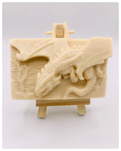 Load image into Gallery viewer, Dragon gift. Dinosaur gift. Our Flying Dragon soap features a striking dragon with its majestic wings spread wide, symbolising freedom and power. This artisan bar is vegan, cruelty-free, and designed with care for both your skin and the planet. Available in your choice of colour and essential oil. Each soap comes beautifully wrapped in eco friendly packaging. zero waste gift. kodern gift ideas. handmade home style. eco conscious home. eco friendly gifts. go green home.