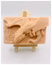 Load image into Gallery viewer, Dragon gift. Dinosaur gift. Our Flying Dragon soap features a striking dragon with its majestic wings spread wide, symbolising freedom and power. This artisan bar is vegan, cruelty-free, and designed with care for both your skin and the planet. Available in your choice of colour and essential oil. Each soap comes beautifully wrapped in eco friendly packaging. zero waste gift. kodern gift ideas. handmade home style. eco conscious home. eco friendly gifts. go green home.