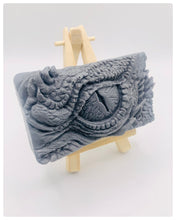 Load image into Gallery viewer, dragon Gift | dragon eye gift, dino gift, alternative gift, Dragon / Dinosaur Eye Vegan Soap Wooden display easels are available to purchase on a separate listing Calling all fantasy lovers! Step into a realm of mystical charm with our captivating dragon / dinosaur eye soap. This soap is vegan, cruelty free and available in your choice of colour and essential oil. All our soaps are made with natural clays and essential oils to gently cleanse and nourish your skin. eco conscious gift