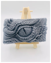 Load image into Gallery viewer, dragon Gift | dragon eye gift, dino gift, alternative gift, Dragon / Dinosaur Eye Vegan Soap Wooden display easels are available to purchase on a separate listing Calling all fantasy lovers! Step into a realm of mystical charm with our captivating dragon / dinosaur eye soap. This soap is vegan, cruelty free and available in your choice of colour and essential oil. All our soaps are made with natural clays and essential oils to gently cleanse and nourish your skin. eco conscious gift