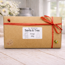 Load image into Gallery viewer, Kraft paper box with orange ribbon and 'Santa & Tree' label on a wooden surface.