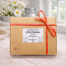 Load image into Gallery viewer, Two handmade vegan soaps in the shape of plump, realistic chicken sculptures with detailed feather textures, displayed on a rustic white wooden surface in a bright farmhouse decor setting.